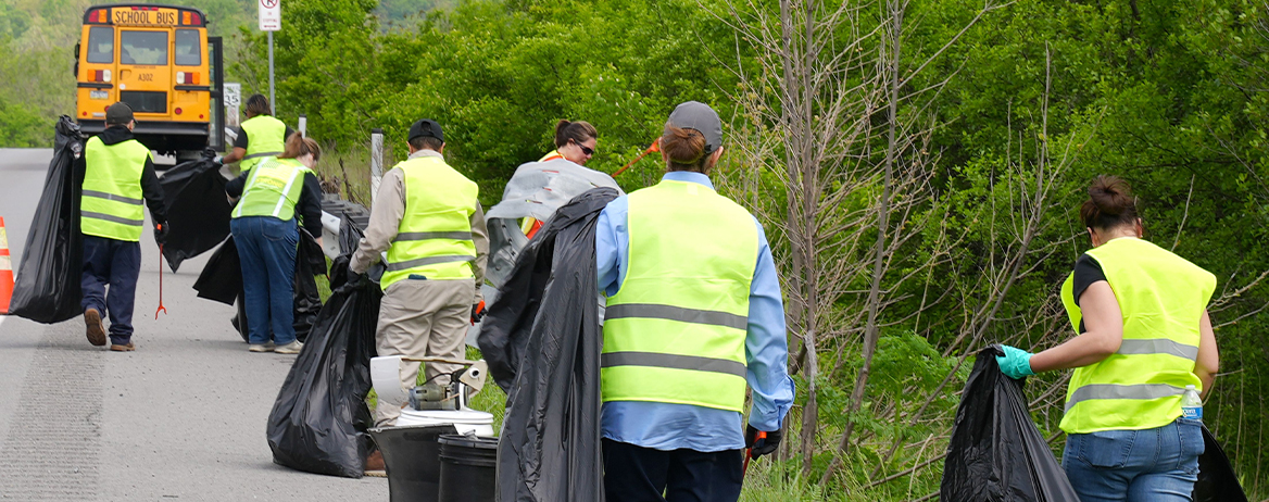 ALCOSAN employees picking up litter on the side of the roadway
