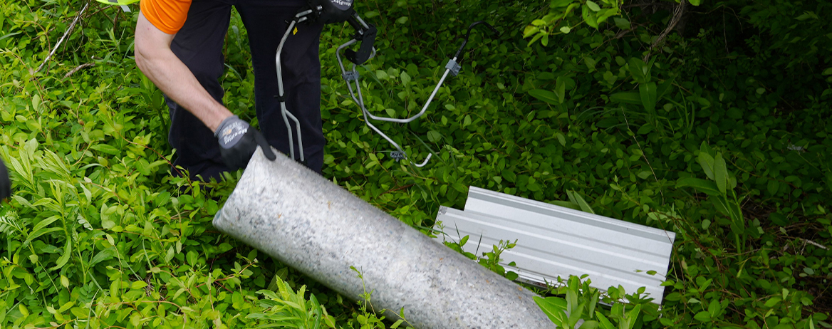 ALCOSAN employee removing large litter objects