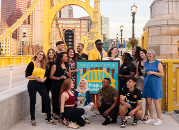 Men and Women standing together on the Clemente Bridge