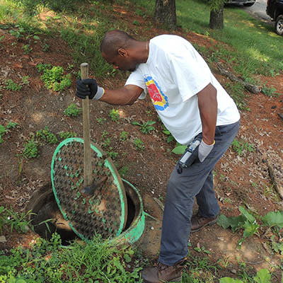 An employee inspects a portion of the sewer