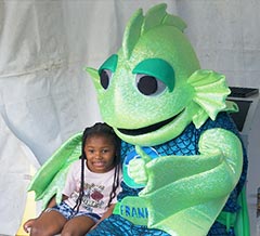Young girl sitting with Frankie the fish