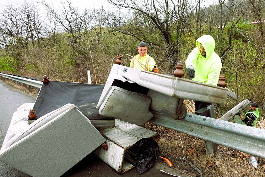 ALCOSAN employees picking up furniture on the side of the road